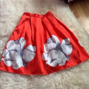 Red silky skirt with white flowers